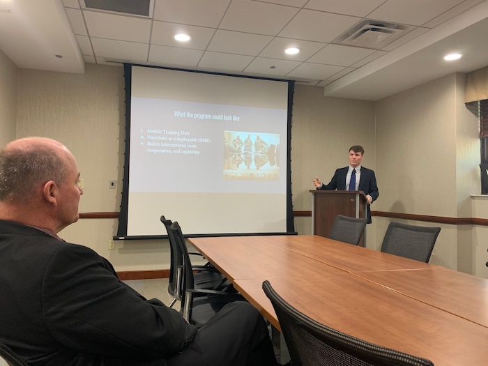 Photo of e-intern briefing Air Combat Command International Affairs division chief