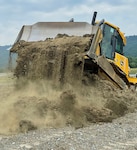 An Airmen assigned to the 175th Civil Engineer Squadron, Maryland Air National Guard, maneuvers a piece of heavy equipment at Fort Indiantown Gap, Pennsylvania, June 22, 2022. The Airmen of the 175th CES trained at the 201st Regional Training Site to gain proficiency in their career field.