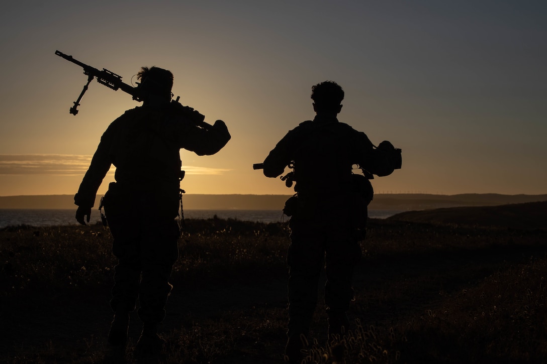 U.S. Marines with 1st Battalion, 8th Marine Division, 2nd Marine Division, hike to an objective during Spanish FLOTEX-22 near Rota, Spain, June 22, 2022. This exercise features tactical level actions ashore, combined with joint training and planning, aimed at increasing overall bilateral interoperability between nations.