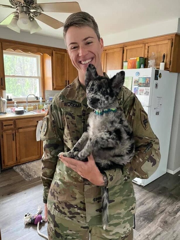 Capt. Shannon Woodman, a civil affairs officer with the 443rd Civil Affairs Battalion located in Newport, Rhode Island, poses with her puppy.