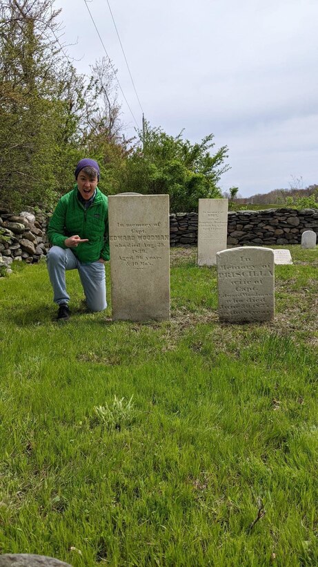 Capt. Shannon Woodman, a civil affairs officer with the 443rd Civil Affairs Battalion, located in Newport, Rhode Island, excitedly poses with a headstone belonging to one of her ancestors. Woodman recently moved to the area for her military job and discovered she had ancestral roots in the area. She visited the area with her fiancée, Stefi.