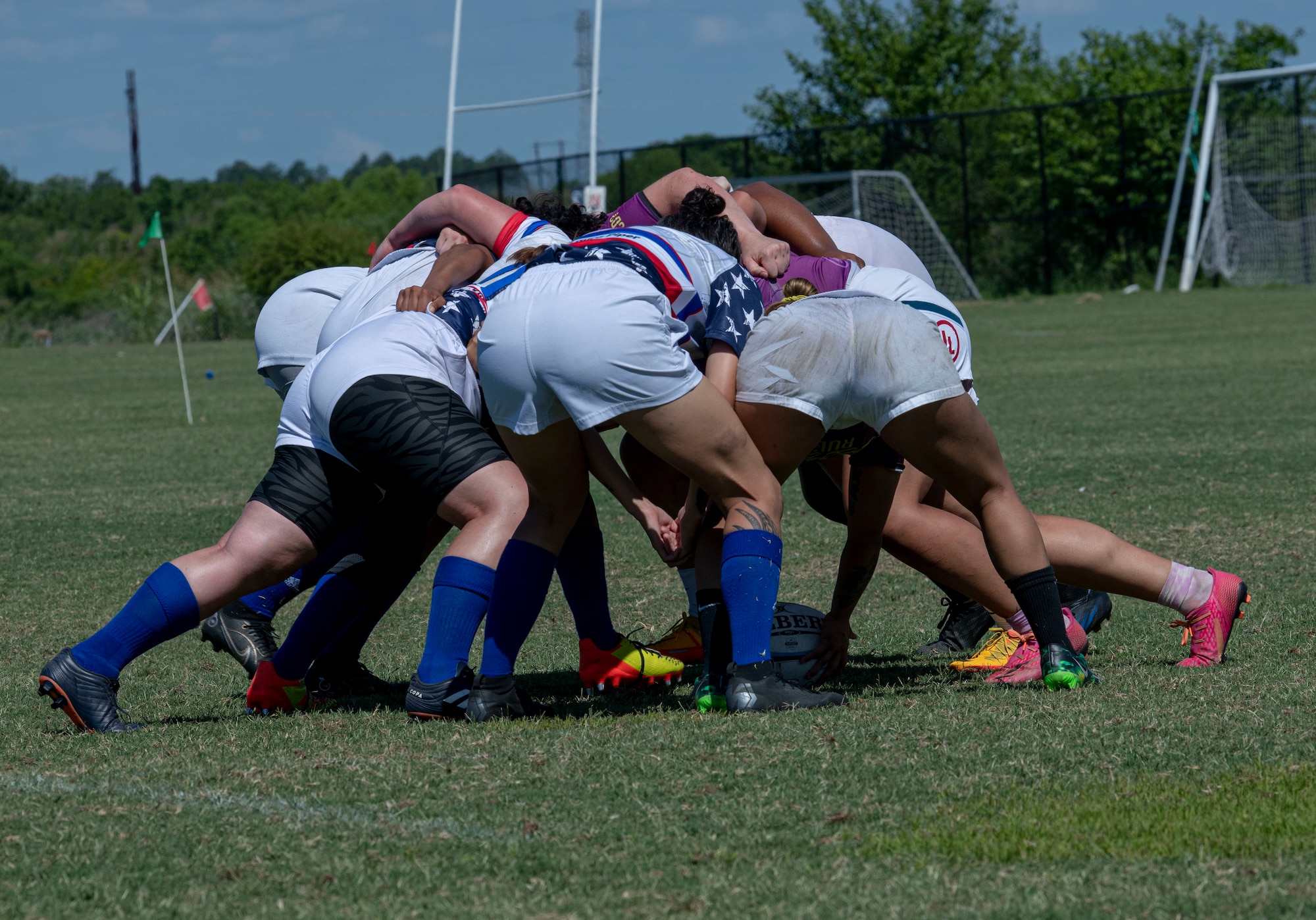 Members of the Department of Air Force Women's Rugby Team form a scrum, where players bind together and shove against each other to retrieve the ball, during a game against the Northern Virginia Rugby Team after competing in the Annual Armed Forces Women’s Rugby Championship in Wilmington, North Carolina, June 26, 2022. The competition played rugby sevens, which means every team was made up of seven players playing 7-minute halves. (U.S. Air Force photo by Airman 1st Class Sabrina Fuller)