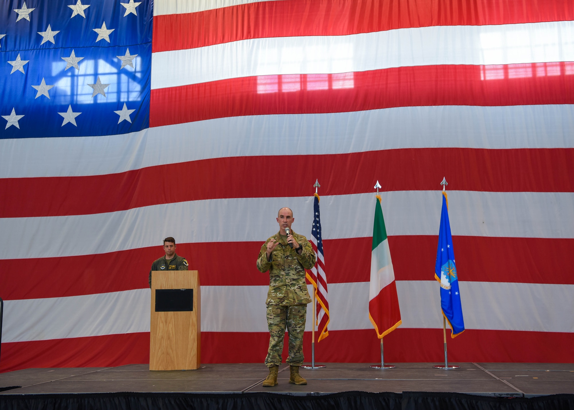 U.S. Air Force Brig. Gen. Jason Bailey, 31st Fighter Wing commander, gives final remarks at his 31st FW final all-call at Aviano Air Base, Italy, June 30, 2022. Bailey is scheduled to have his change of command ceremony July 18, 2022. The wing’s diverse mission sets are executed by Airmen that fly, maintain and support two F-16C Fighting Falcon fighter squadrons, two combat search and rescue squadrons with pararescue Airmen and HH-60 Pave Hawks, U.S. Air Forces Europe’s only air control squadron, agile combat support squadrons, medical squadrons and numerous wing staff agencies. (U.S. Air Force photo by Senior Airman Brooke Moeder)