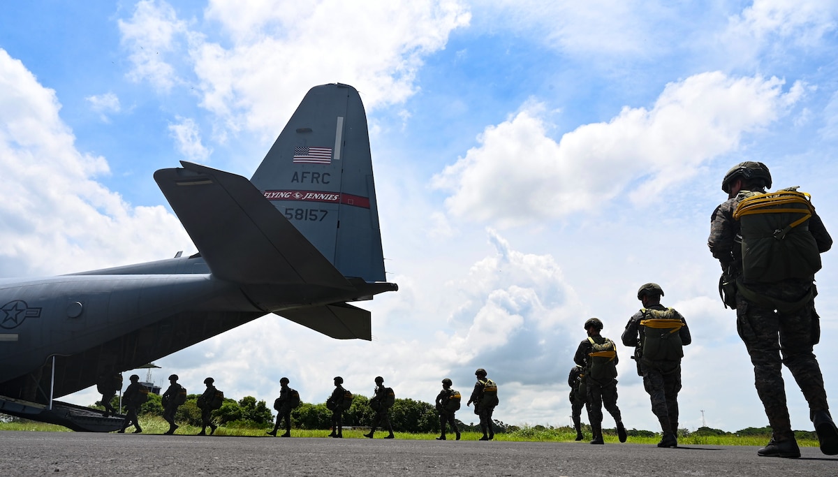 Guatemalan military service members board a C-130J Super Hercules for a parachute jump.