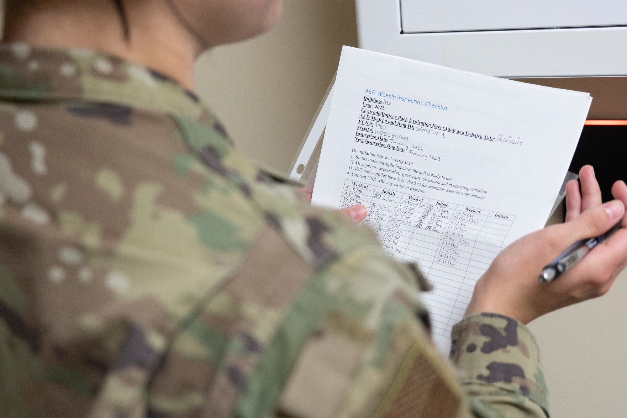 Staff Sgt. Alyssa Day, Air Force Mortuary Affairs Operations safety representative, reviews an inspection checklist for an automated external defibrillator June 30, 2022 at Dover Air Force Base, Delaware. Regular inspections of equipment help AFMAO stay ready for inspection at a moment's notice. (U.S. Air Force photo by Tech. Sgt. Katie Maricle)
