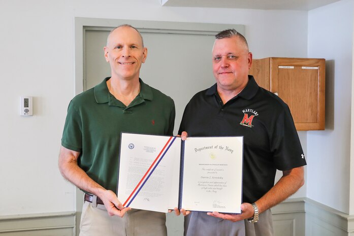 NSWC IHD Technical Director Ashley Johnson presents the command’s former Chief of Staff Darrin Kravitsky the DON Meritorious Civilian Service Award, June 21. (U.S. Navy photo by Matthew Poynor)