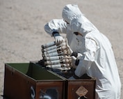 U.S. Air Force National Guard Master Sgt. Derin Creek and Staff Sgt. Cody Bialcak, Explosive Ordnance Disposal Techinicians, safely remove over 500 depleted uranium rounds on June 23, 2022 at Tooele Army Depot, UT.