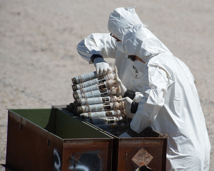 U.S. Air Force National Guard Master Sgt. Derin Creek and Staff Sgt. Cody Bialcak, Explosive Ordnance Disposal Techinicians, safely remove over 500 depleted uranium rounds on June 23, 2022 at Tooele Army Depot, UT.