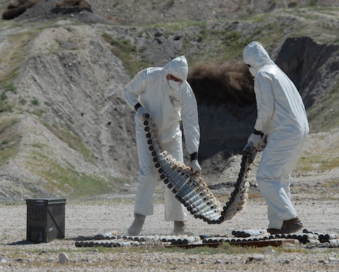 U.S. Air Force National Guard Master Sgt. Derin Creek and Staff Sgt. Cody Bialcak, Explosive Ordnance Disposal Techinicians, safely remove over 500 depleted uranium rounds on June 23, 2022 at Tooele Army Depot, UT.