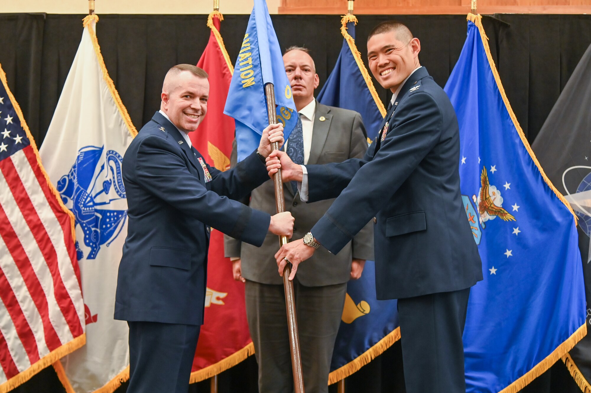 Right, Col. Jason K. Okumara, incoming Defense Logistics Agency Aviation at Ogden commander, receives the guidon from Brig. Gen. David Sanford, Defense Supply Center Richmond and DLA Aviation commander, during a change of command ceremony