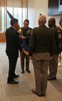 Brig. Gen. Christopher Schneider receives the Army Acquisition Corps flag from Assistant Secretary of the Army for Acquisition, Logistics, and Technology Mr. Douglas Bush, signifying his assumption as Program Executive Officer for PEO Soldier, during a change of charter ceremony at Fort Belvoir, Virginia, June 21, 2022