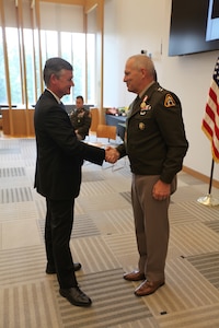 Assistant Secretary of the Army for Acquisition, Logistics, and Technology Mr. Douglas Bush thanks Maj. Gen. Anthony Potts for his service as Program Executive Officer, PEO Soldier, at Fort Belvoir, Virginia, June 21, 2022.