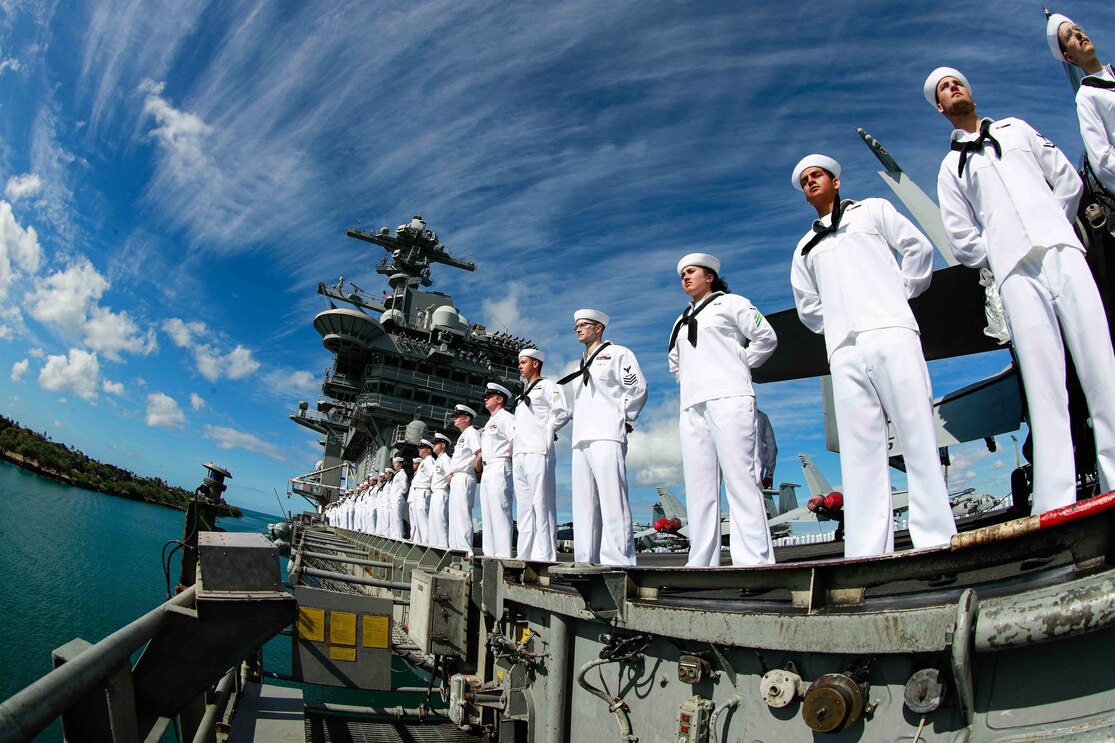 Sailors man the rails as the Nimitz-class aircraft carrier USS Abraham Lincoln (CVN 72) pulls into Joint Base Pearl Harbor-Hickam during Rim of the Pacific (RIMPAC) 2022.