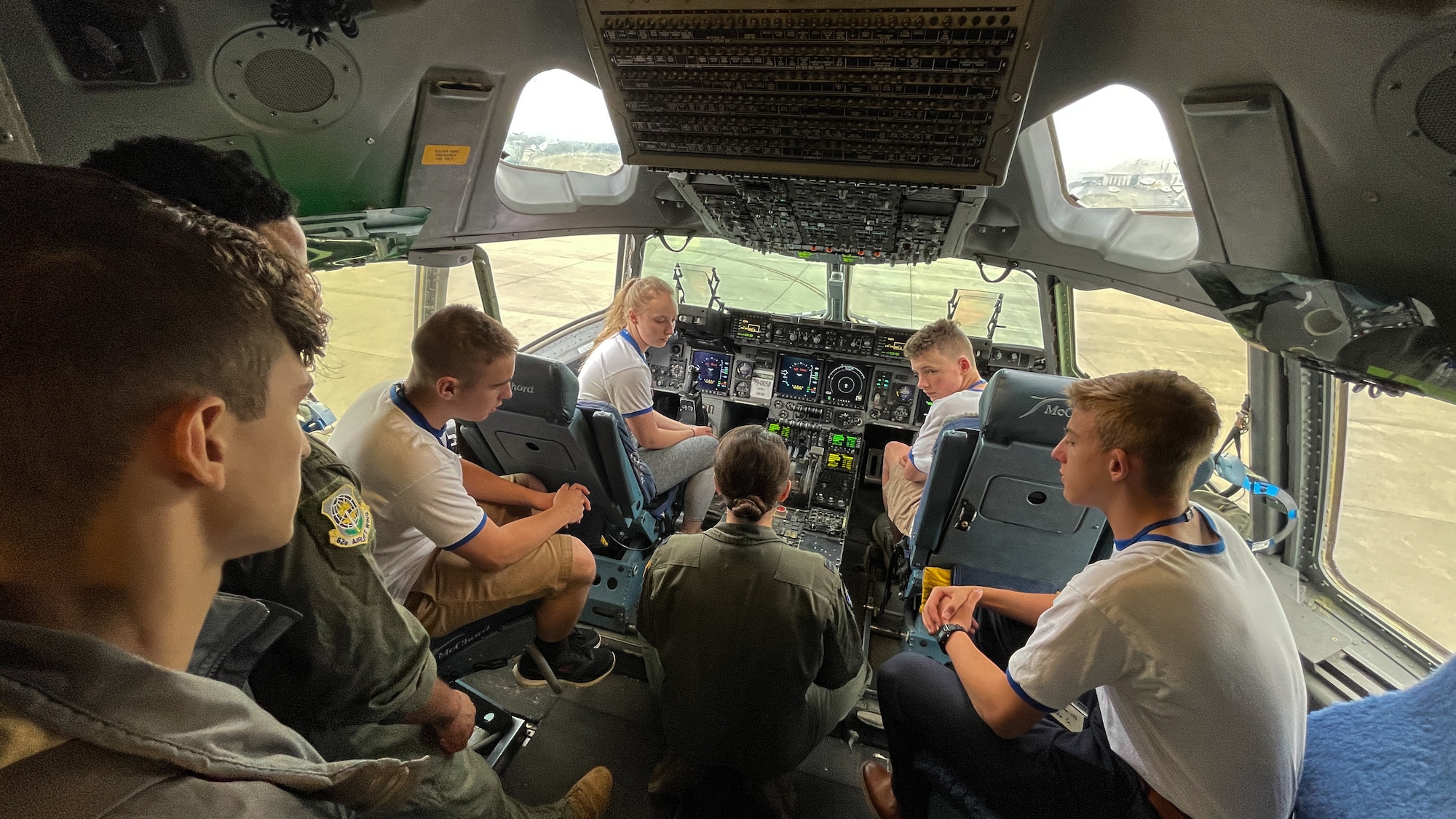 U.S. Capt. Gabriella Basham, 8th Airlift Squadron scheduler, provides a tour of a C-17 Globemaster III to Northwest Youth Leadership Conference attendees as part of Aviation Inspiration and Mentorship (AIM) Wing event at Joint Base Lewis-McChord, Washington, June 28, 2022. AIM Wing is a community outreach program to inform, influence and inspire the next generation of Air Force aviators. (U.S. Air Force photo by Master Sgt Julius Delos Reyes)