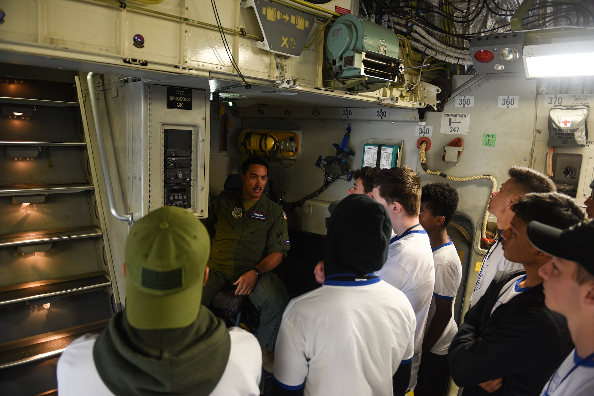 U.S. Air Force Staff Sgt. Gabriel Gonzalez, 4th Airlift Squadron loadmaster, provides a tour to Northwest Youth Leadership Conference attendees as part of Aviation Inspiration and Mentorship (AIM) Wing event at Joint Base Lewis-McChord, Washington, June 28, 2022. AIM Wing is a community outreach program to inform, influence and inspire the next generation of Air Force aviators. (U.S. Air Force photo by Master Sgt Julius Delos Reyes)