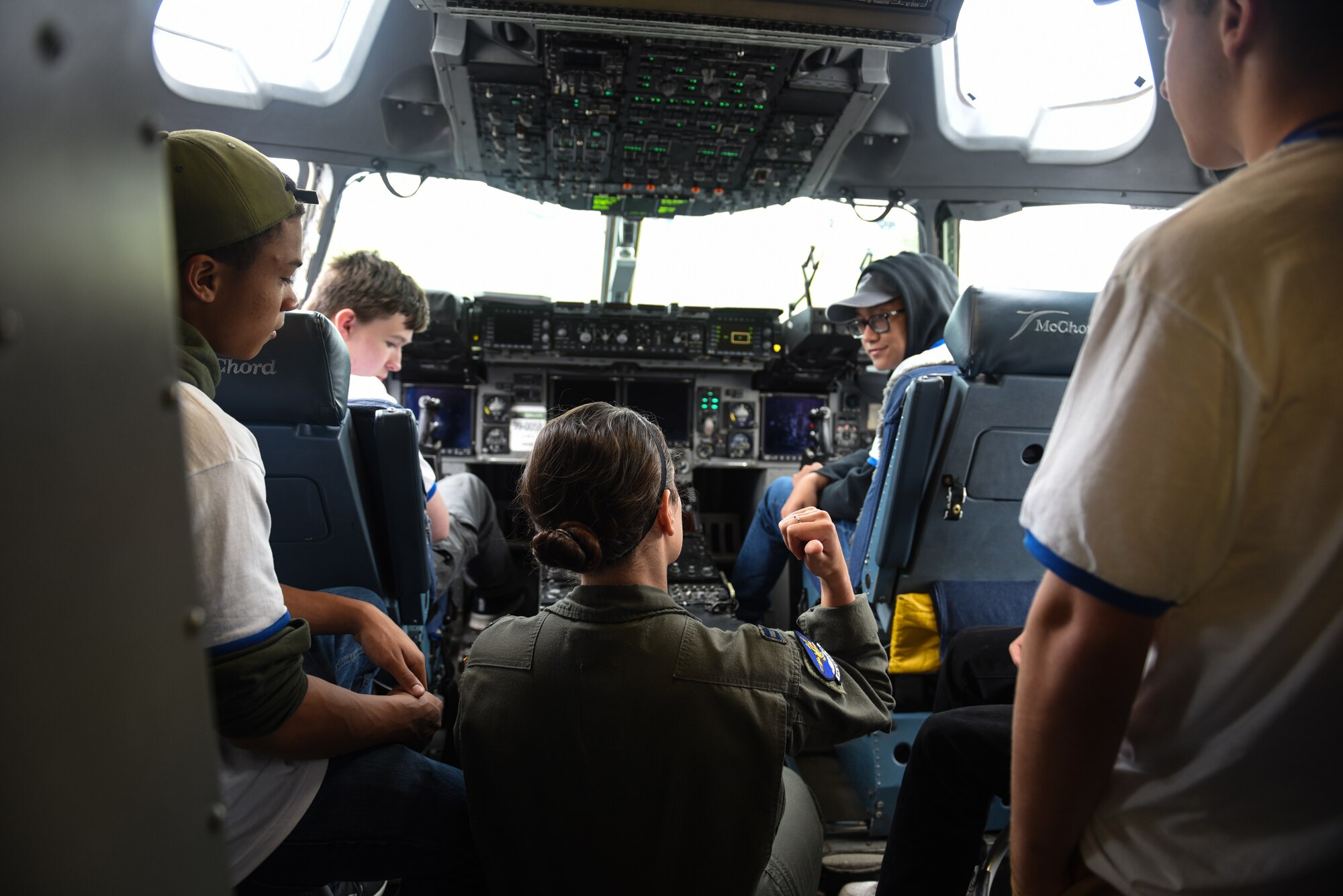 U.S. Capt. Gabriella Basham, 8th Airlift Squadron scheduler, provides a tour of a C-17 Globemaster III to Northwest Youth Leadership Conference attendees as part of Aviation Inspiration and Mentorship (AIM) Wing event at Joint Base Lewis-McChord, Washington, June 28, 2022. AIM Wing is a community outreach program to inform, influence and inspire the next generation of Air Force aviators. (U.S. Air Force photo by Master Sgt Julius Delos Reyes)