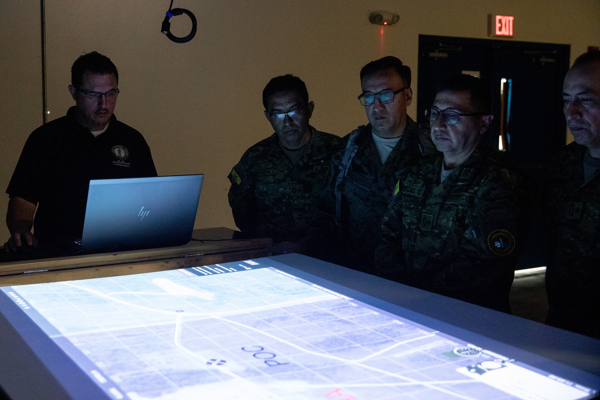 Army National Guard contractor Frank Peak demonstrates how their instructors use virtual sand-tables to servicemembers from Ecuador at Wendell H. Ford Regional Training Center in Greenville, Ky. on June 29, 2022. Ecuadorian enlisted servicemembers visited the 238th RTI to exchange instructor techniques and procedures in part of the State Partnership Program. (U.S. Army photo by Andy Dickson)
