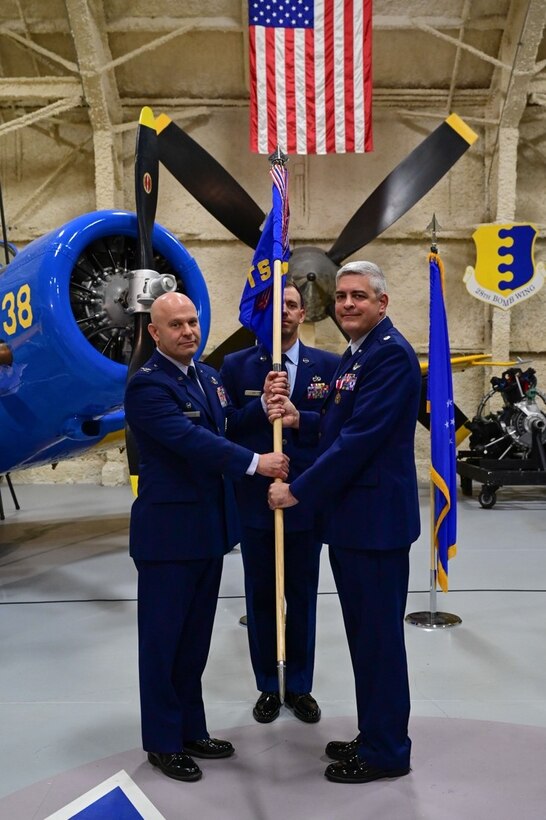 Col. Joseph Sheffield, the 28th Bomb Wing commander, relinquishes Lt. Col. Kenneth Byrd, the 28th Comptroller Squadron outgoing commander, of his command of the 28th Comptroller Squadron at Ellsworth Air Force Base, S.D., June 30, 2022.