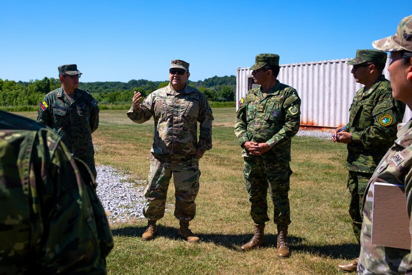 Kentucky Army National Guard's Maj. Oscar Ortiz explains the use of one of the urban training sites to servicemembers from Ecuador at Wendell H. Ford Regional Training Center in Greenville, Ky. on June 29, 2022. Ecuadorian enlisted servicemembers visited the 238th RTI to exchange instructor techniques and procedures in part of the State Partnership Program. (U.S. Army photo by Andy Dickson)