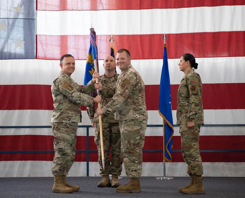 Col. Nathan Mitchell, the 28th Maintenance Group commander, relinquishes Lt. Col. Joshua Allen, the 28th Munitions Squadron outgoing commander, of his command of the 28th Munitions Squadron at Ellsworth Air Force Base, S.D., June 29, 2022.