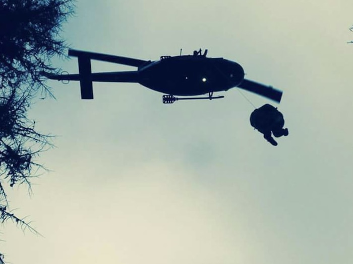 A UH-1N Huey, assigned to the 36th Rescue Squadron, commanded by Maj. Jason Vero, hoists up rescue personnel and a survivor during a medical evacuation. (Courtesy photo)