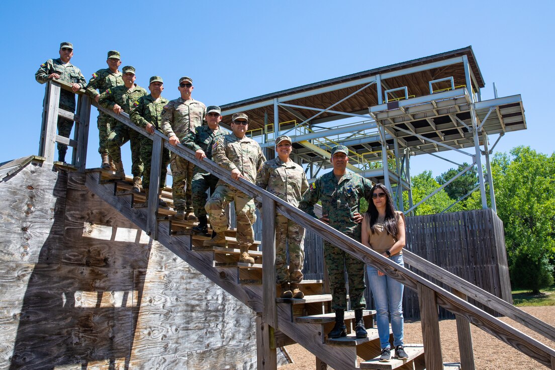 Kentucky Army National Guard and Ecuadorian enlisted instructors pose for a group photo at the rappel tower at Wendell H. Ford Regional Training Center in Greenville, Ky. on June 29, 2022. Ecuadorian enlisted servicemembers visited the 238th RTI to exchange instructor techniques and procedures in part of the State Partnership Program. (U.S. Army photo by Andy Dickson)