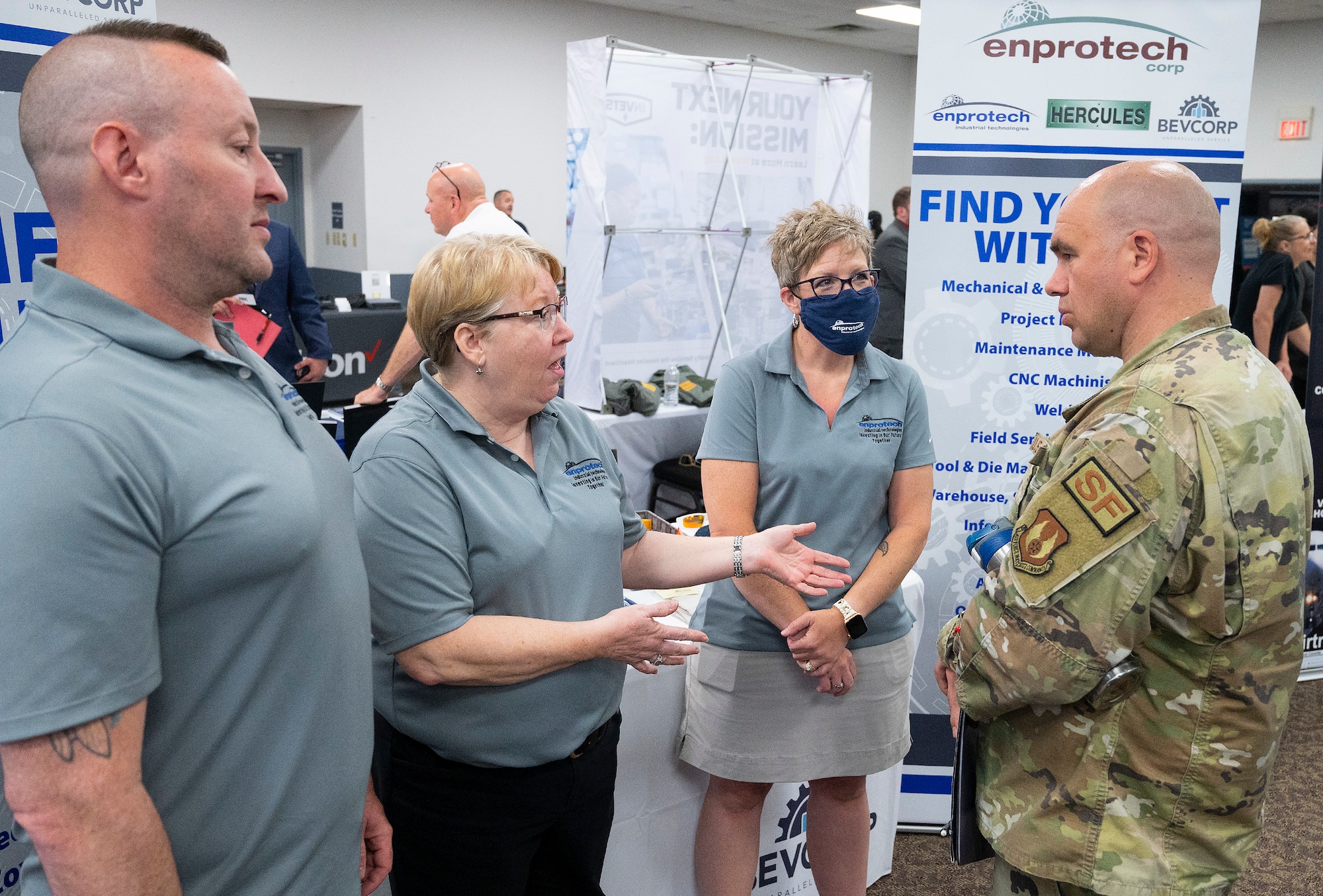 Senior Master Sgt. Joshua Stephenson, 88th Security Forces Squadron, listens to a team from Enprotech tell him about career opportunities during the Hire Our Heroes event June 22, 2022, at the Hope Hotel, Wright-Patterson Air Force Base, Ohio. Enprotech was just one of the more than 50 companies, with more than 50 thousand job openings, who set up tables to talk with active-duty Airmen, recent retirees and spouses. (U.S. Air Force photo by R.J. Oriez)