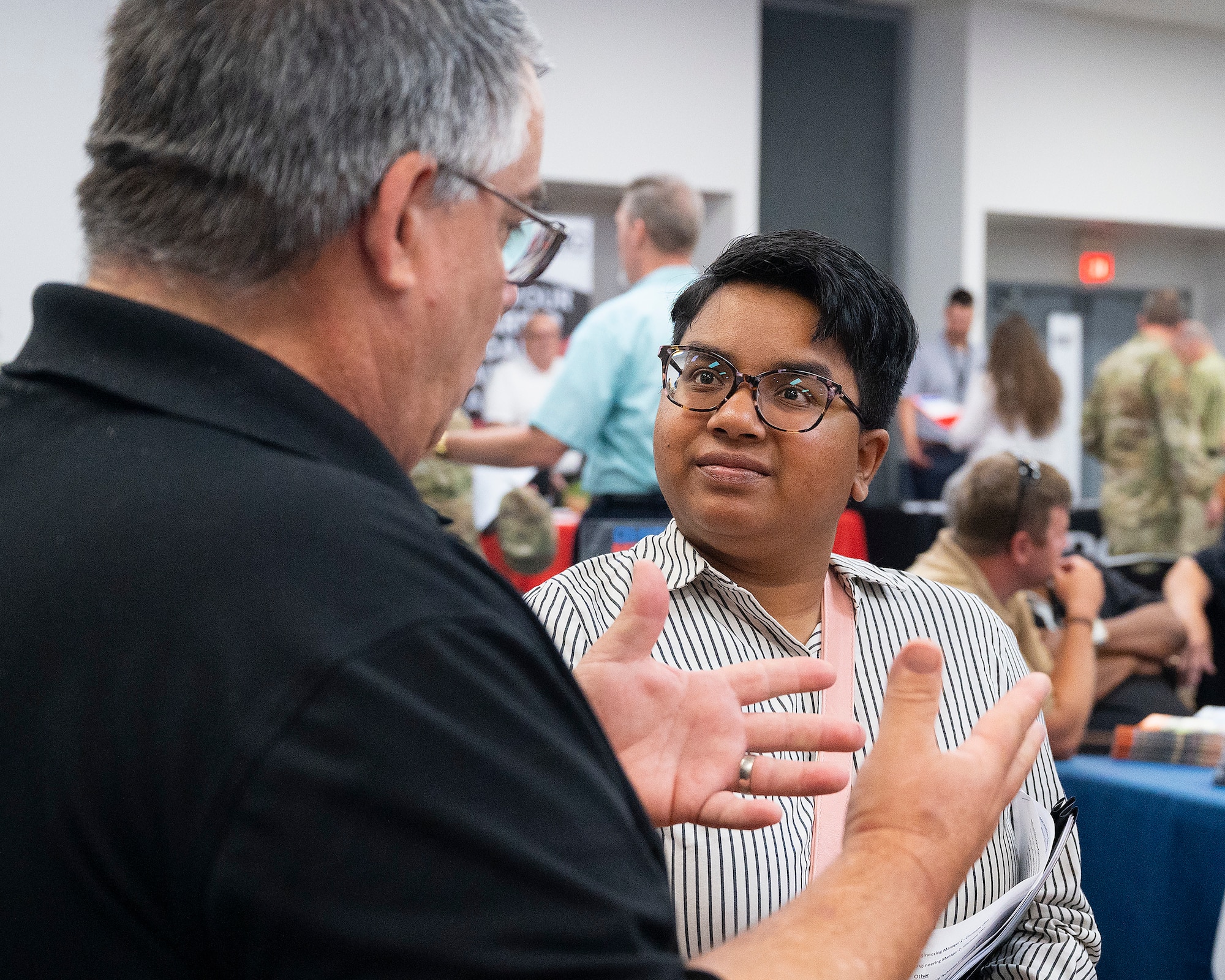eresa Burch, a recent retiree, listens to Patrick Moynihan, a Crown Lift Trucks representative, about job opportunities while attending the Hire Our Heroes event June 22, 2022, at the Hope Hotel, Wright-Patterson Air Force Base, Ohio. Crown, part of the material handling industry, was looking for Airmen about to separate, or who have recently separated, from the service to fill positions with the company. (U.S. Air Force photo by R.J. Oriez)