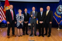 Mr. Tommy Ross, Performing the Duties of ASN RDA, left, and Mr. Frederick J. (Jay) Stefany, Principal Civilian Deputy to ASN RDA, right, present a team award to members of the CVN 78 Full Ship Shock Trials Team at Naval Surface Warfare Center (NSWC) Carderock Division during the June 16 ceremony for the Assistant Secretary of the Navy (ASN) for Research, Development and Acquisition (RDA) Dr. Delores M. Etter Top Scientists and Engineers for 2022 at NSWC Carderock Division.