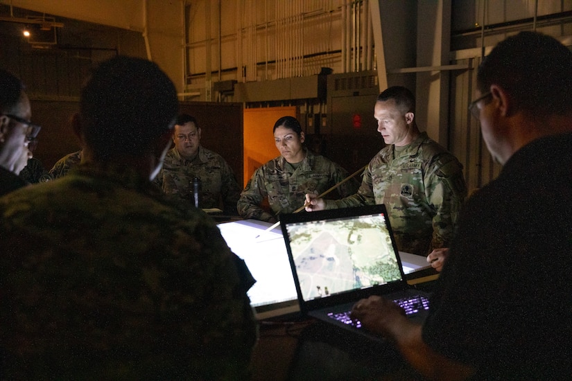 Kentucky Army National Guard's Sgt. 1st Class Clinton Scott from the 238th Regional Training Institute demonstrates how their instructors use virtual sand-tables to servicemembers from Ecuador at Wendell H. Ford Regional Training Center in Greenville, Ky. on June 29, 2022. Ecuadorian enlisted servicemembers visited the 238th RTI to exchange instructor techniques and procedures in part of the State Partnership Program. (U.S. Army photo by Andy Dickson)