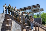 Kentucky Army National Guard and Ecuadorian enlisted instructors pose for a photo at the rappel tower at Wendell H. Ford Regional Training Center in Greenville, Ky., June 29, 2022. Ecuadorian enlisted service members visited the 238th RTI to exchange instructor techniques and procedures as part of the State Partnership Program.