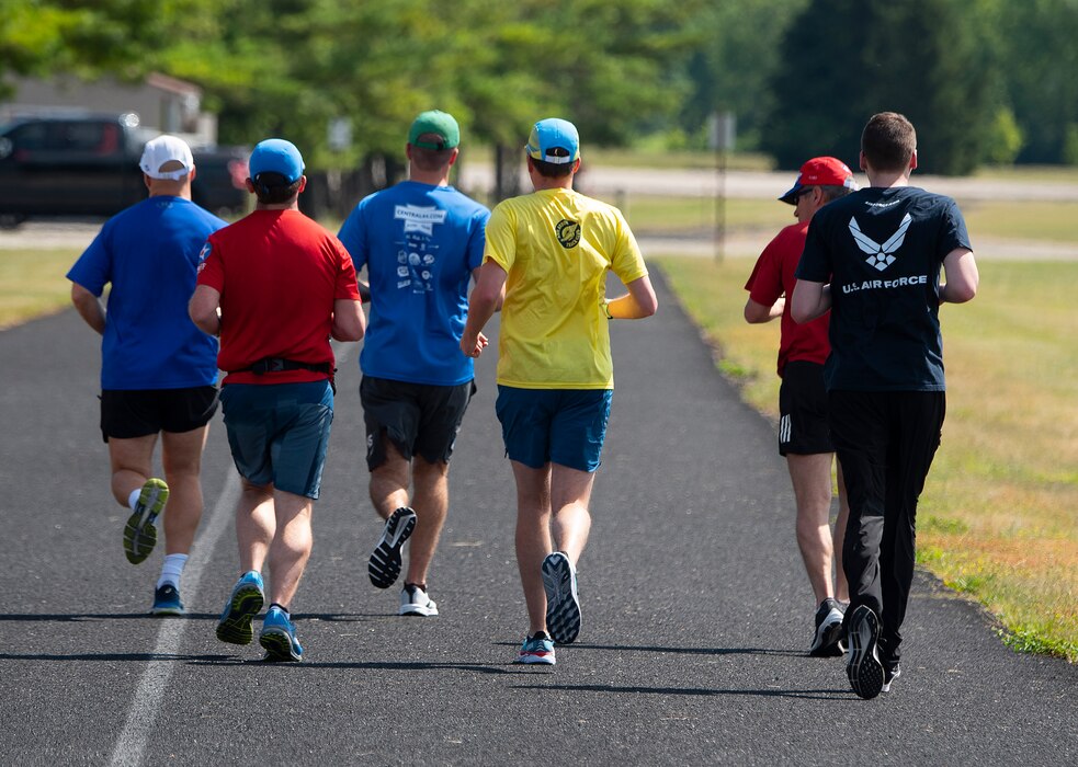 Airmen, civilians and family members run on a track along Skeel Avenue at Wright-Patterson Air Force Base on July 27. Air Force Marathon officials say running improves sleep, productivity and mood. (U.S. Air Force photo by R.J. Oriez)