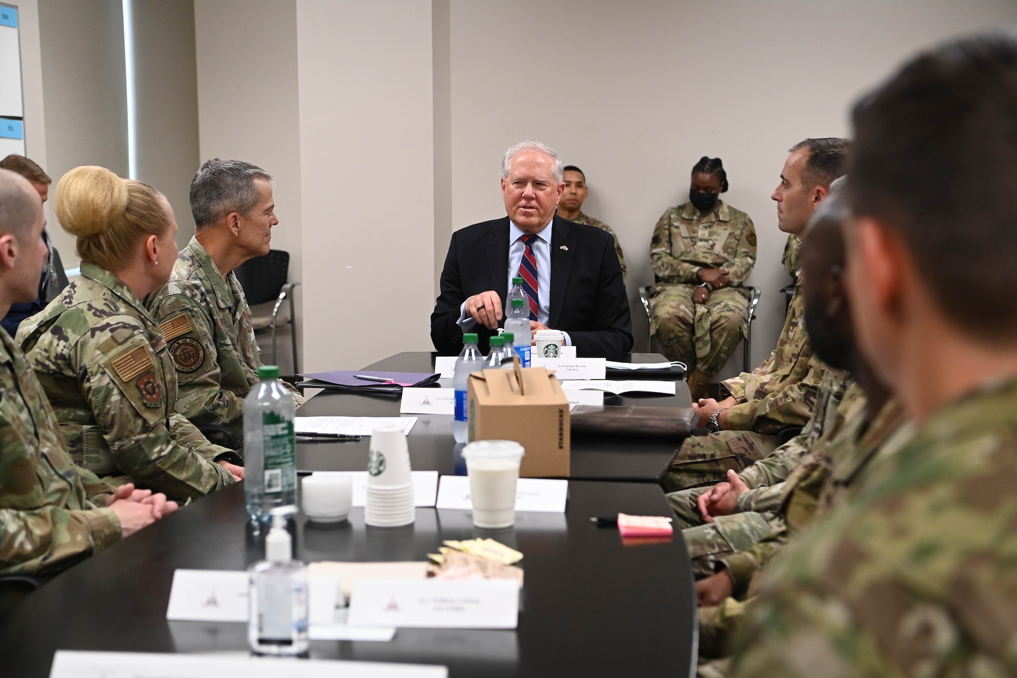 Image of a group of people talking around a table.