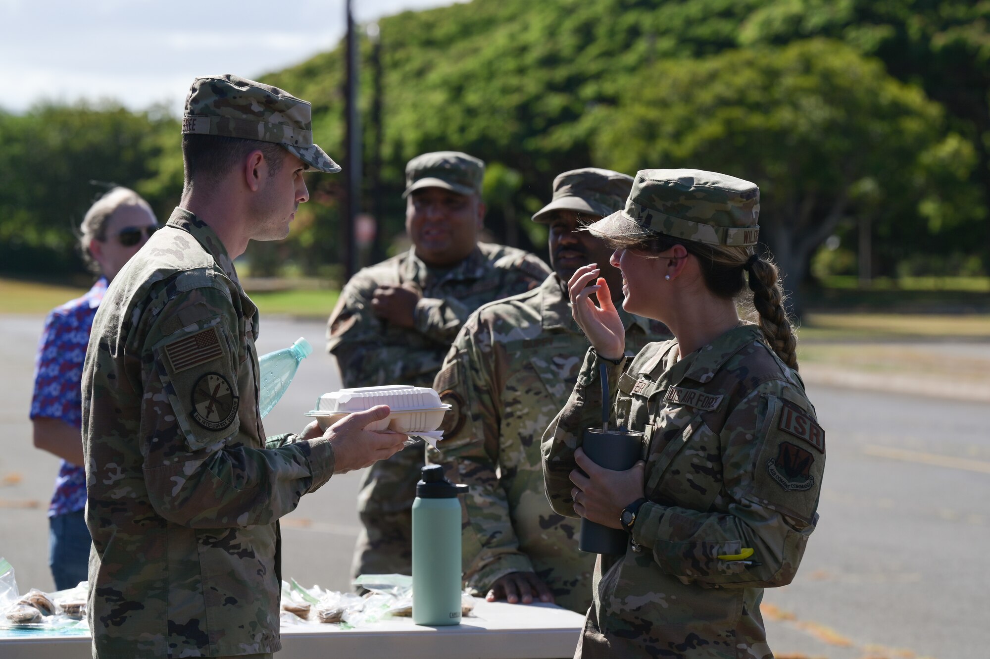 Military dorm residents enjoy free food during a “Feed the Dorms” event near the Hale Aina Dining Facility at Joint Base Pearl Harbor-Hickam, Hawaii, June 29, 2022. The event was hosted by the Hickam Chief’s Group, providing residents with 100 free meals. (U.S. Air Force photo by Staff Sgt. Alan Ricker)