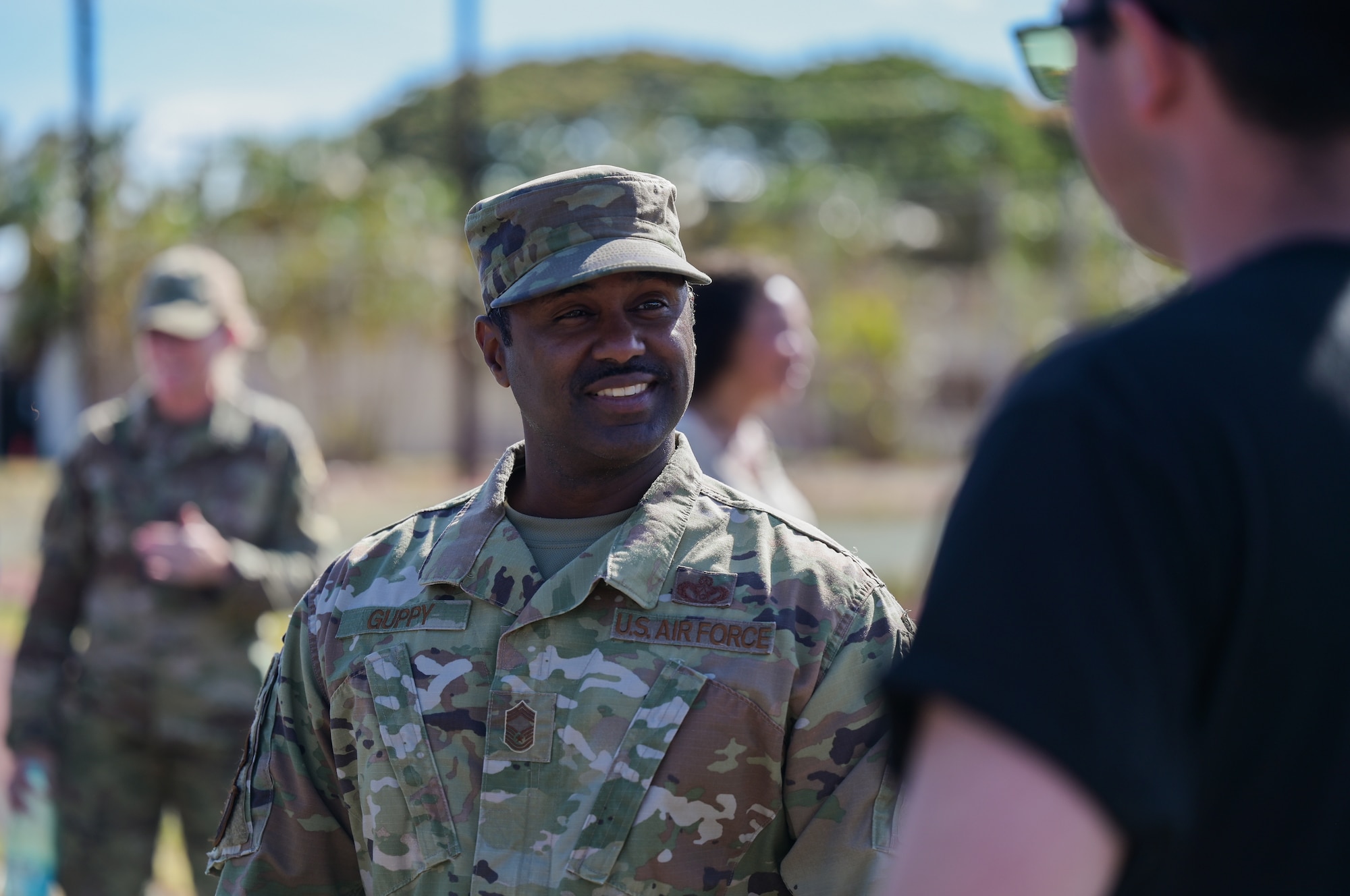 Chief Master Sgt. Darryl Guppy, 647th Civil Engineer Squadron senior enlisted leader, speaks with Senior Airman Ruel Denoon, 647th CES heating, ventilation, and air conditioning journeyman, during a “Feed the Dorms” event near the Hale Aina Dining Facility at Joint Base Pearl Harbor-Hickam, Hawaii, June 29, 2022. Military dorm residents were invited to join members from the Hickam Chief’s Group to enjoy a free meal and conversation. (U.S. Air Force photo by Staff Sgt. Alan Ricker)