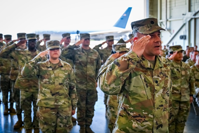 U.S. Airmen assigned to the 305th Maintenance Group render a final salute to U.S. Air Force Col. Mary Teeter, 305th Maintenance Group commander at Joint Base McGuire-Dix-Lakehurst, N.J., June 30, 2022. Teeter relinquished command to U.S. Air Force Col. Scott Pendley after having led CAN DO Airmen during the COVID-19 pandemic and Operations Allies Welcome/Refuge.