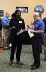 IMAGE: Naval Surface Warfare Center Dahlgren Division (NSWCDD) recruiters converse with a job candidate at the NSWCDD-sponsored Career Fair June 27 at the Fredericksburg Expo and Conference Center.