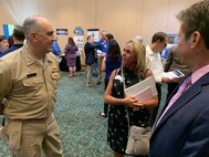 IMAGE: Capt. Phil Mlynarski, Naval Surface Warfare Center Dahlgren Division (NSWCDD) Commanding Officer speaks with a candidate at the NSWCDD Job Fair on June 27.