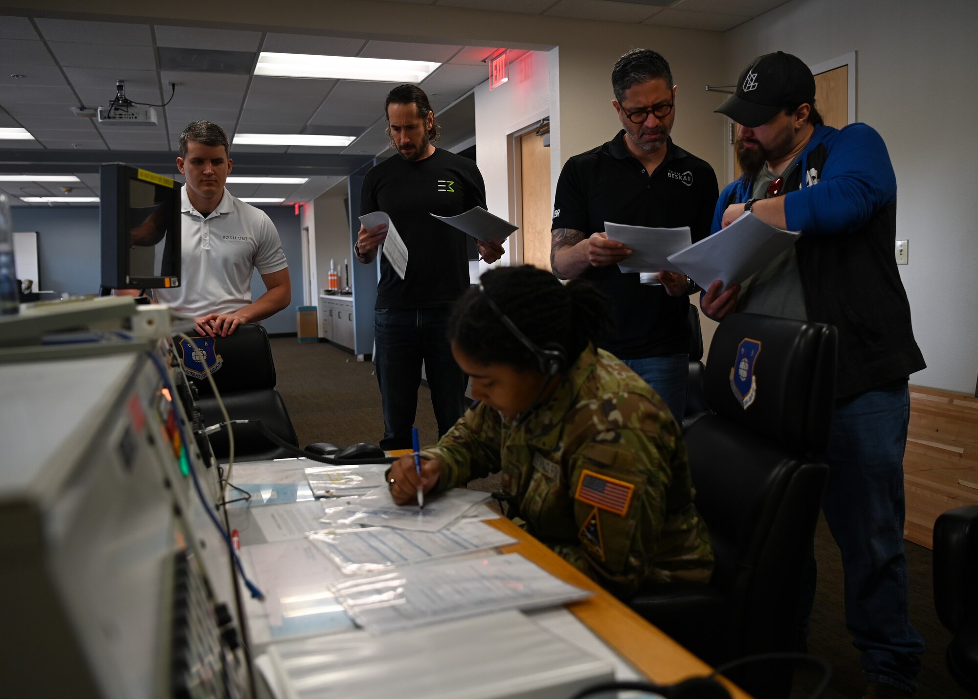 2nd Lt. Taylor Latimer, 2nd Range Operations Squadron range operations commander, walks industry partners through a simulated console exercise at Vandenberg Space Force Base, Calif., June 24, 2022. The console exercise demonstrated how the members at 2ROPS communicate with different parties to get real-time information during space launches. (U.S. Space Force photo by Airman 1st Class Tiarra Sibley)