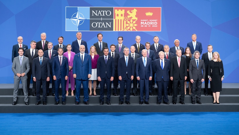 Leaders of government stand bore a sign indicating that they are at the NATO Summit in Madrid, June 28-30, 2022.