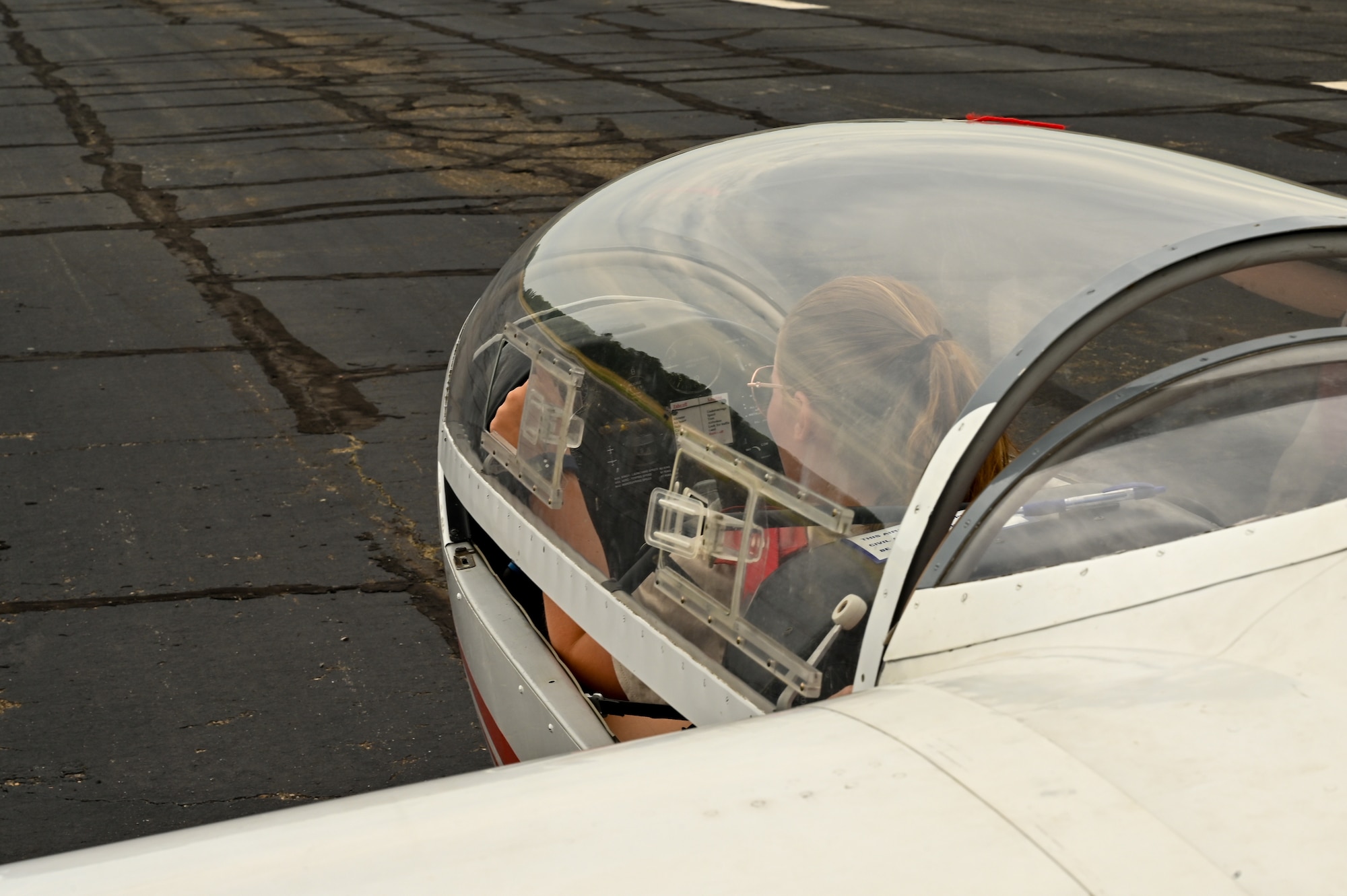 Civil Air Patrol 1st Lt. Emma Tetley, Virginia Wing student, closes the canopy on an L-23 Super Blanik glider June 27, 2022, at the Sunflower Gliderport in Hutchinson, Kansas. The CAP students come to Hutchinson from across the United States to learn how to fly gliders with instructors from the CAP (U.S. Air Force photo by Senior Airman Zachary Willis)