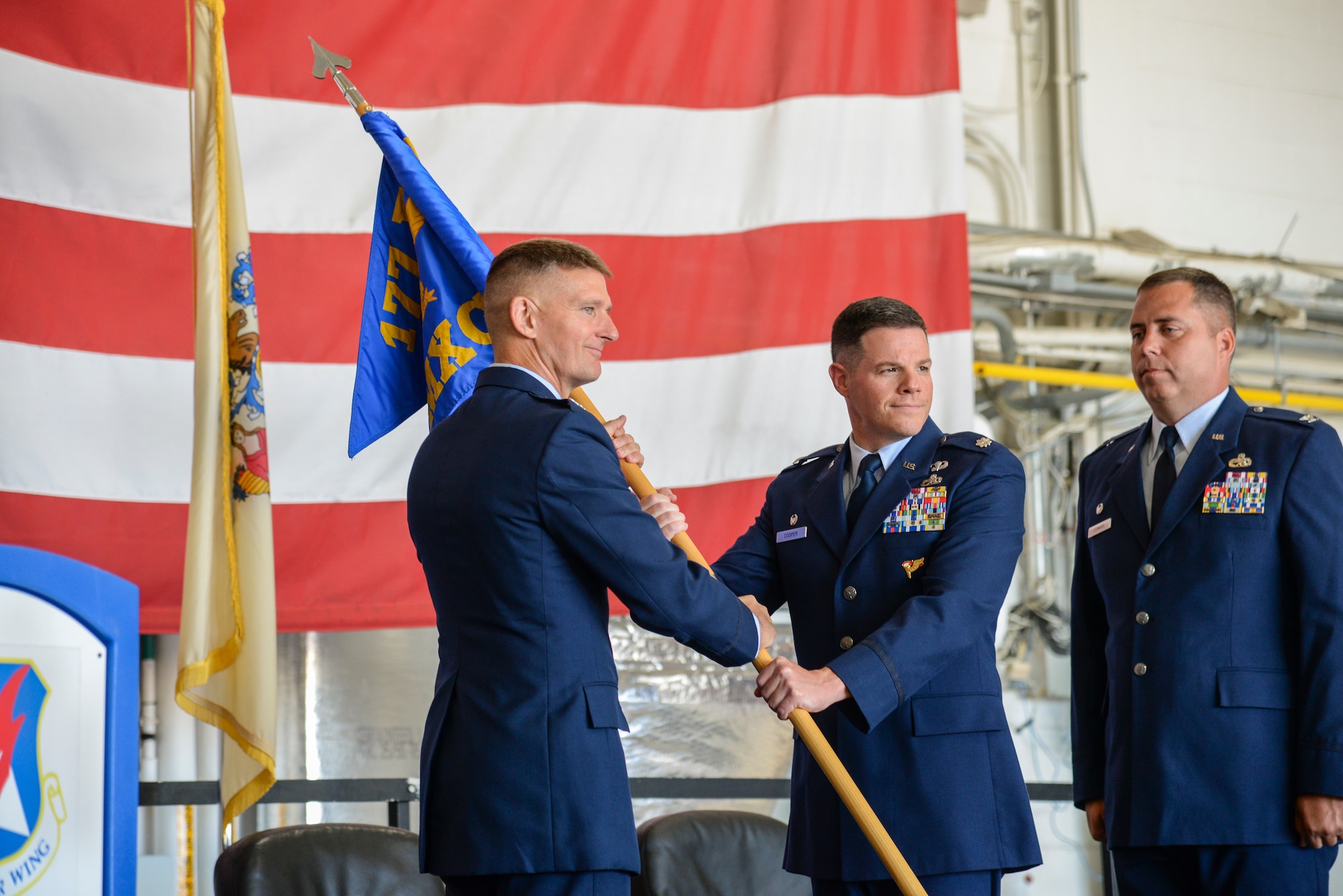 Col. Derek B. Routt passes the 177th Maintenance Group's guideon to Lt. Col. Brian Cooper