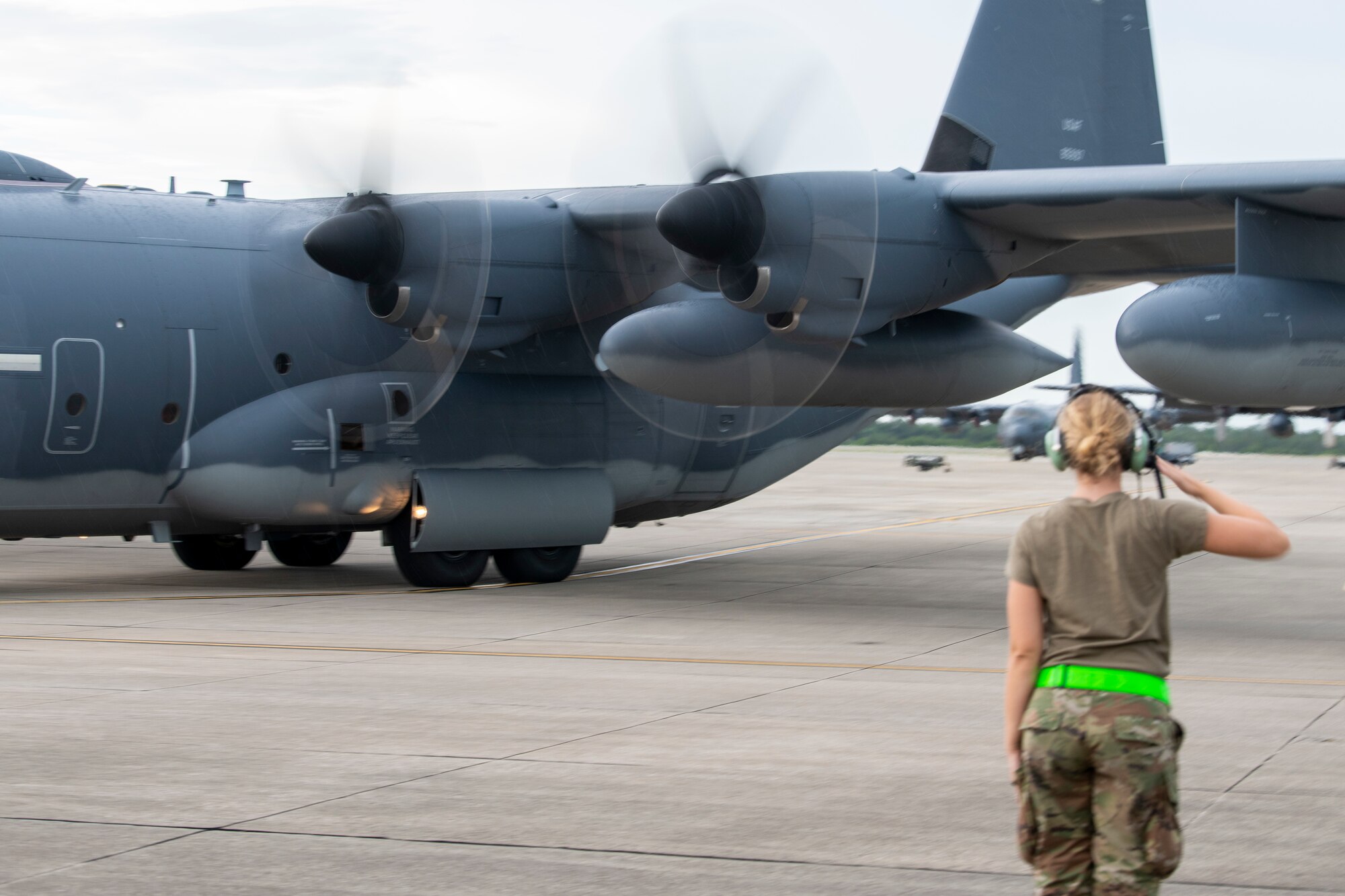 U.S. Air Force Airman 1st Class Natalie Schmidt, 901st Special Operations Aircraft Maintenance Squadron Detachment 2 crew chief, salutes after marshaling a U.S. Air Force MC-130J Commando II June 30, 2022 at Hurlburt Field, Fla. The 901st SOAMXS’s mission is to organize, train, and equip Airmen to perform high-quality aircraft maintenance in order to provide safe and mission-effective aircraft supporting home-station and contingency taskings.