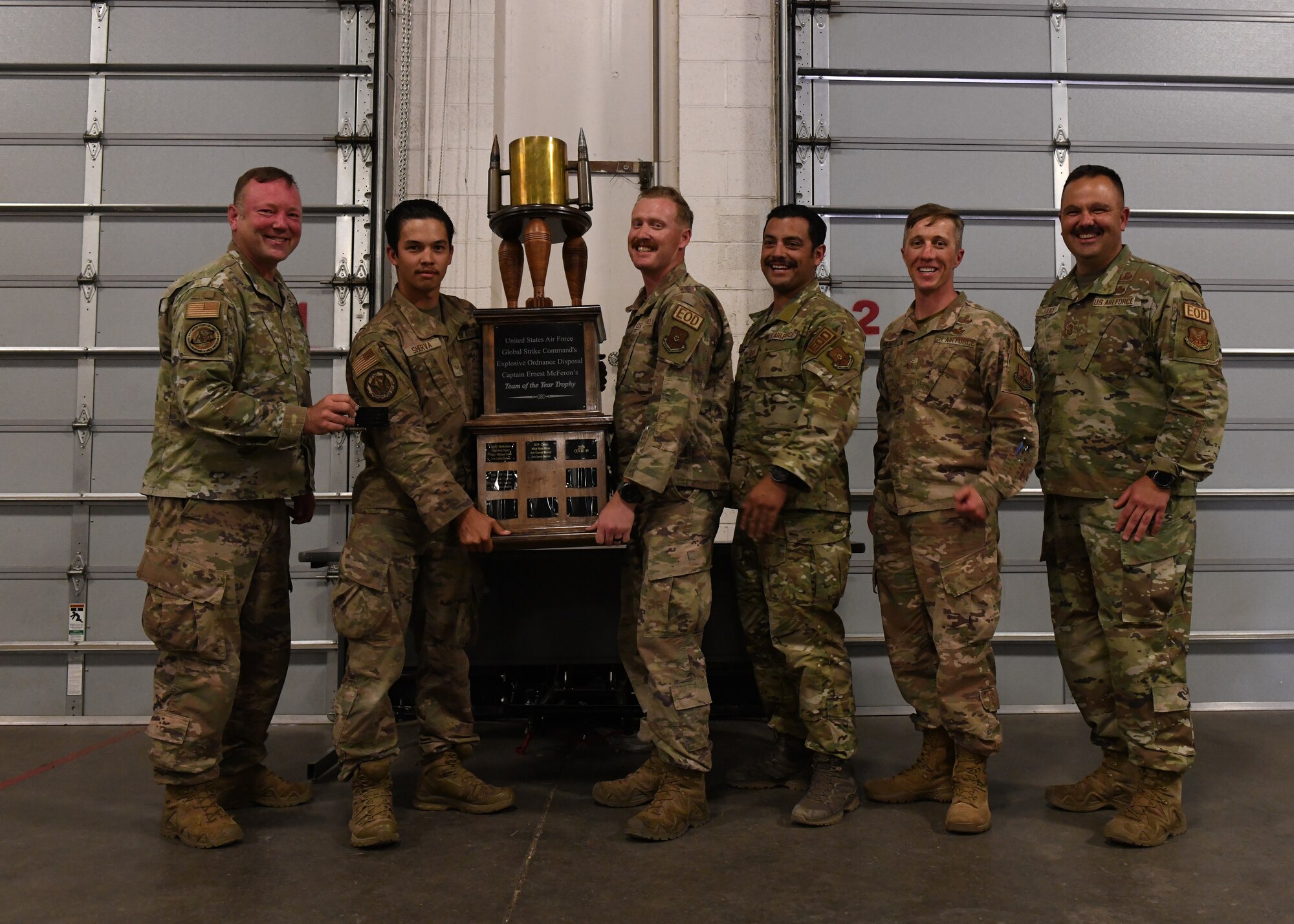 Members from the 5th Civil Engineer Squadrons Explosive Ordinance Disposal team receive the Explosive Ordinance Team of the Year Trophy during the EOD best of best competition on F.E. Warren Air Force Base, Wyoming, June 30, 2022. The best of best competition allowed for teams from multiple Air Force bases to test their skill through various exercises with the top scoring team taking home the trophy. (U.S. Air Force photo by Airman 1st Class Darius Frazier.)