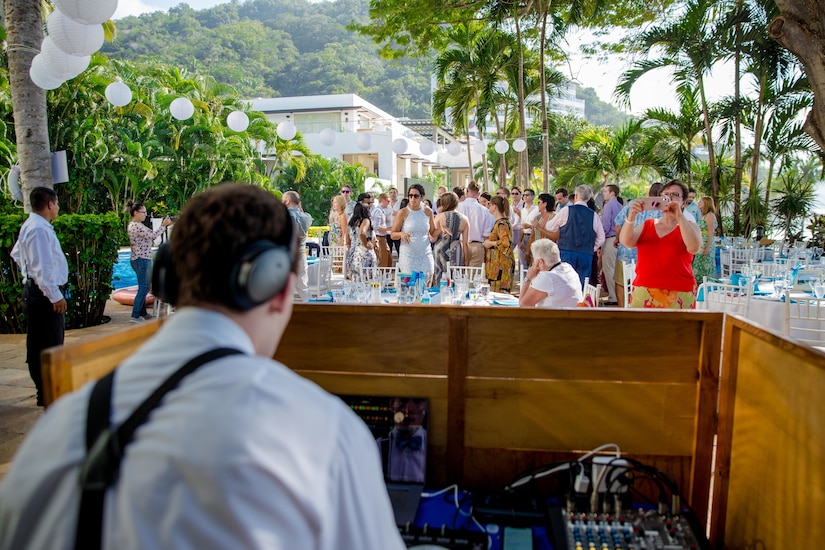 Person DJs at an outdoor wedding.