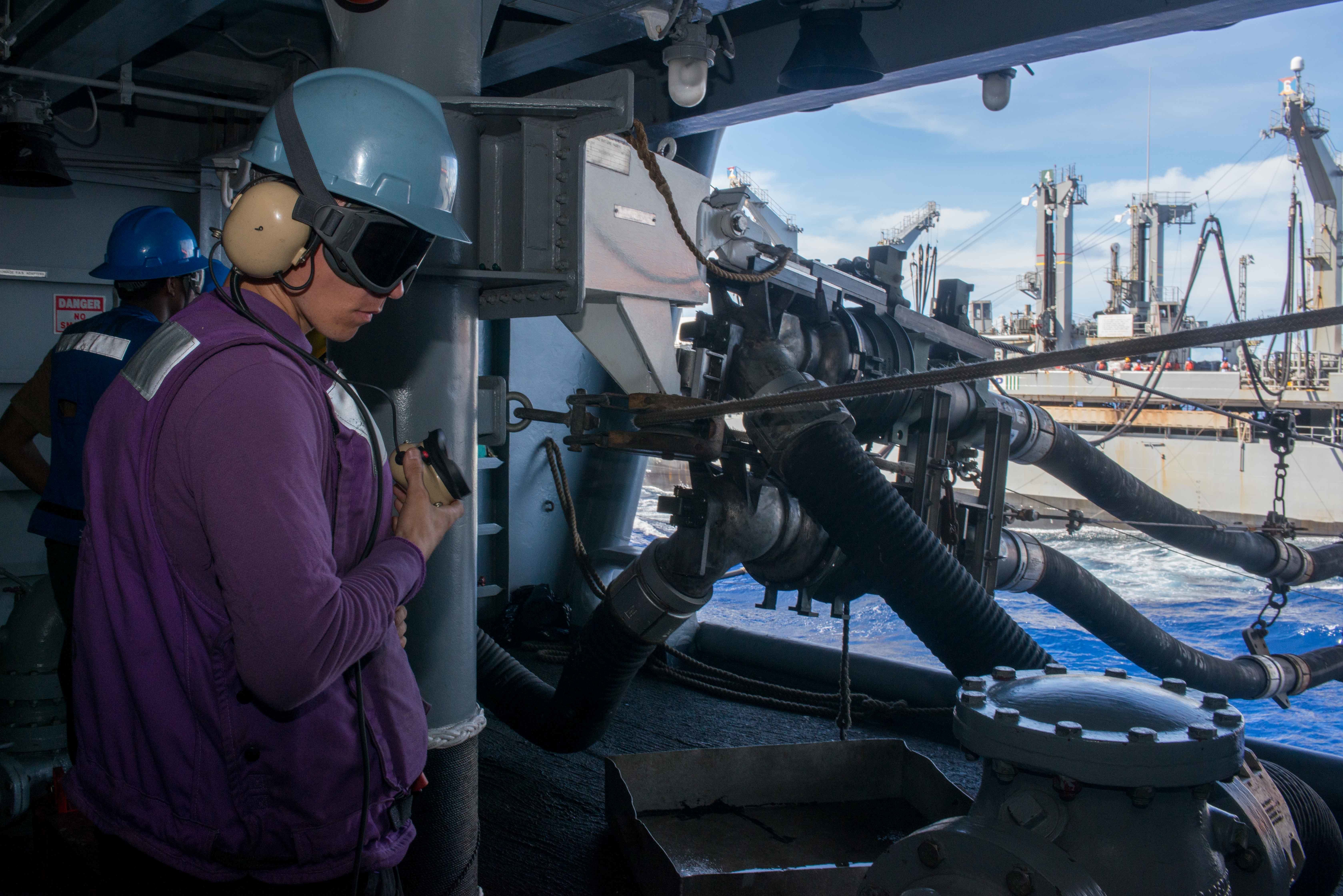 A Sailor uses as sound-powered telephone during a fueling-at-sea with the Military Sealift Command fleet replenishment oiler USNS Yukon (T-AO 202).