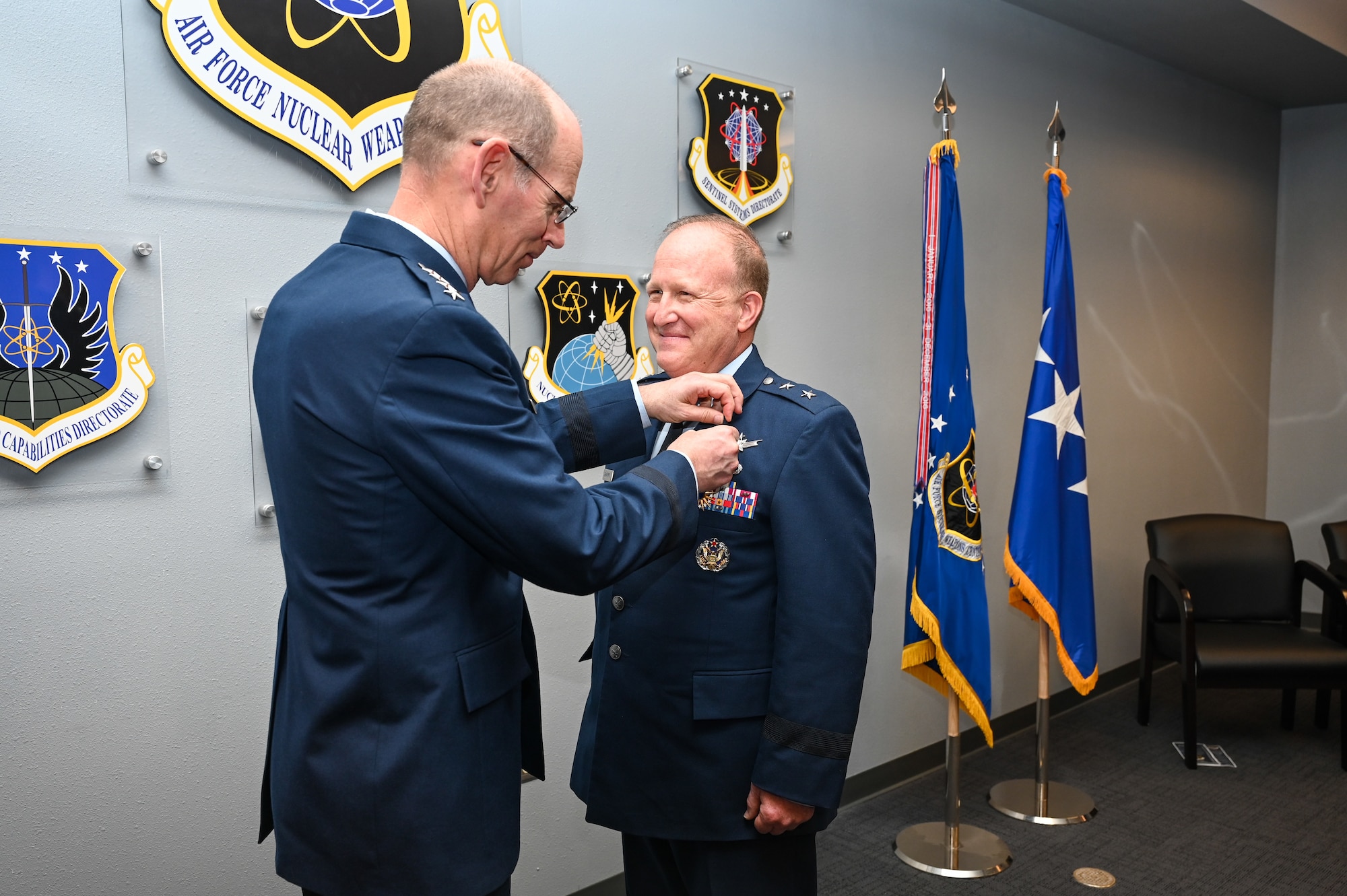 Gen. Duke Z. Richardson, commander of Air Force Materiel Command, pins the Distinguished Service Medal on Maj. Gen. Anthony W. Genatempo, outgoing commander of the Air Force Nuclear Weapons Center, during the change-of-command ceremony at Kirtland Air Force Base, New Mexico, June 21, 2022. Genatempo was awarded the medal for exceptionally meritorious service during his tenure at AFNWC. (U.S. Air Force photo by Staff Sgt. Miranda Loera)