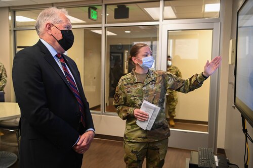 Secretary of the Air Force Frank Kendall is briefed about PTSD Awareness Month and the Learning and Engagement System, or LENS, from Tech Sgt. Jennifer Garrison, 316th Operational Medical Readiness Squadron mental health noncommissioned officer in charge, during a visit to Joint Base Andrews, Md., June 24, 2022. LENS is a tool that enables ready, reliable care and a new method of communication between providers and patients. (U.S. Air Force photo by Airman 1st Class Isabelle Churchill)