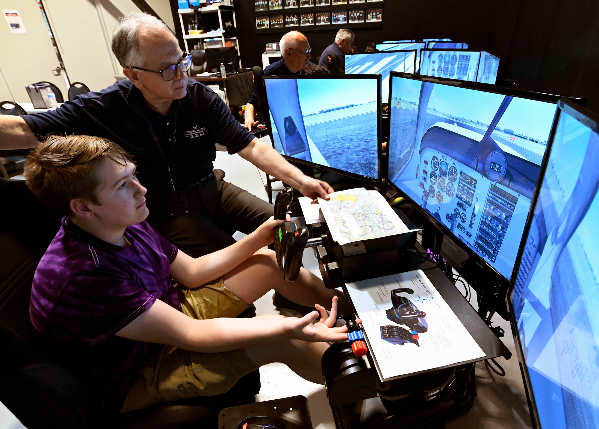 A participant in the Intro to Pilot program learns about airplane instruments on a flight simulator.