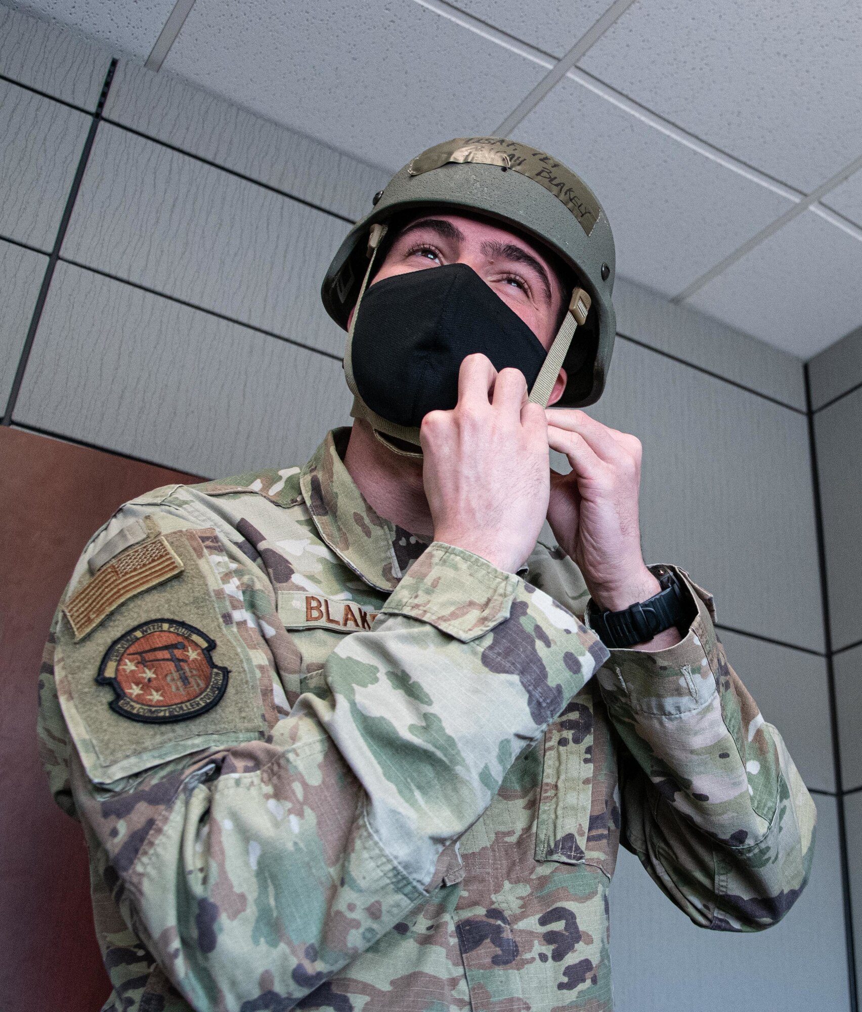 Photo of Airman affixing a helmet.